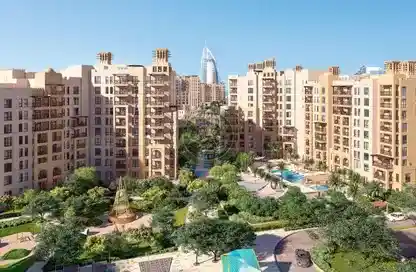 Abstract wavy lines gradient in yellow and orange on a soft blue-gray background.